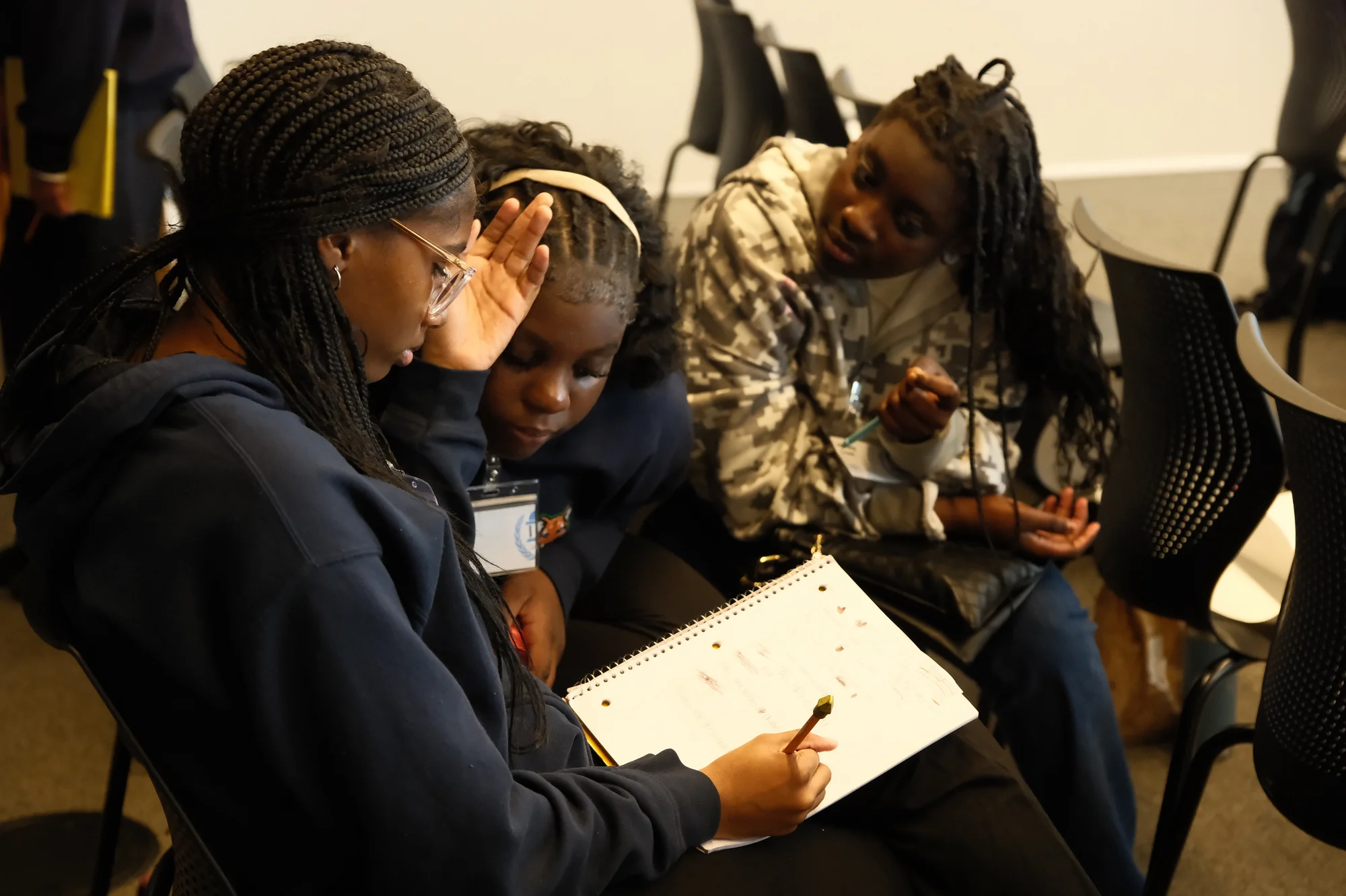 Three JAMUN Mathletes delegates collaborating on a problem set.