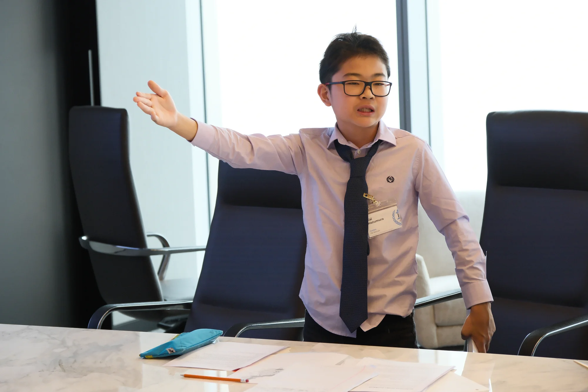 JAMUN Model UN delegate gesturing while making a point in committee.