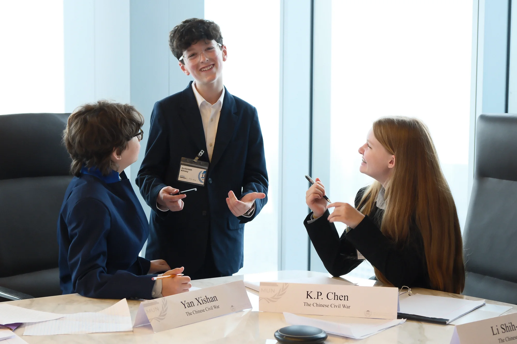 Three JAMUN delegates share a moment during committee.